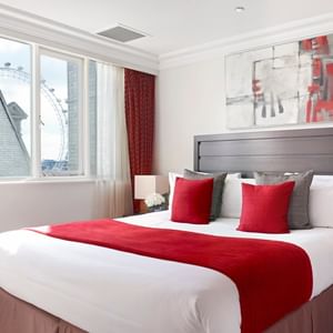 King bed & city view in a room at Guoman Hotels