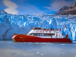 A red cruise ferry sailing in the sea near Hoteles Australis