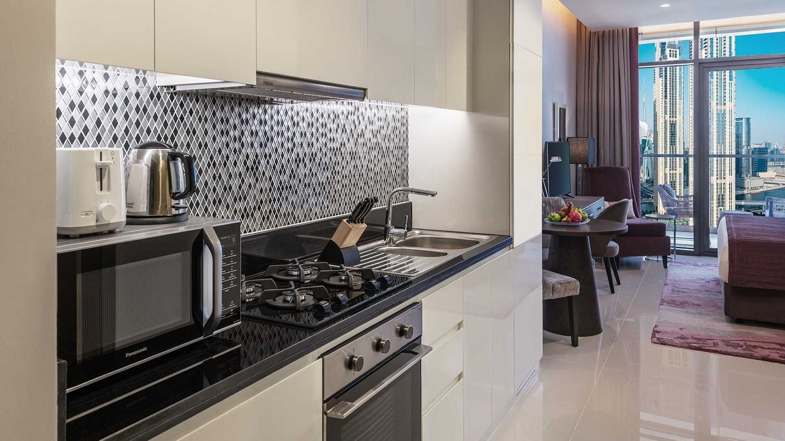 Luxury kitchen area with appliances in Studio Apartments at DAMAC Maison Aykon City