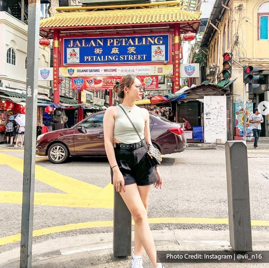 Lady posing by the busy street in Chinatown Petaling Street near Imperial Lexis Kuala Lumpur