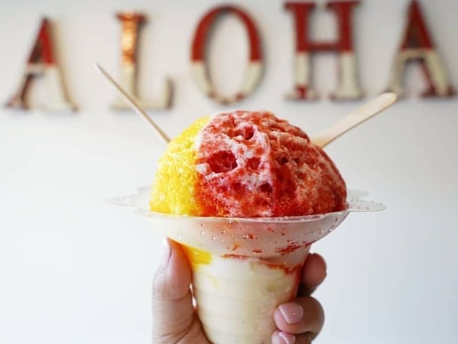 A person holding a Hawaiin Ice Cream in Matsumoto's Shave Ice near Waikiki Resort Hotel