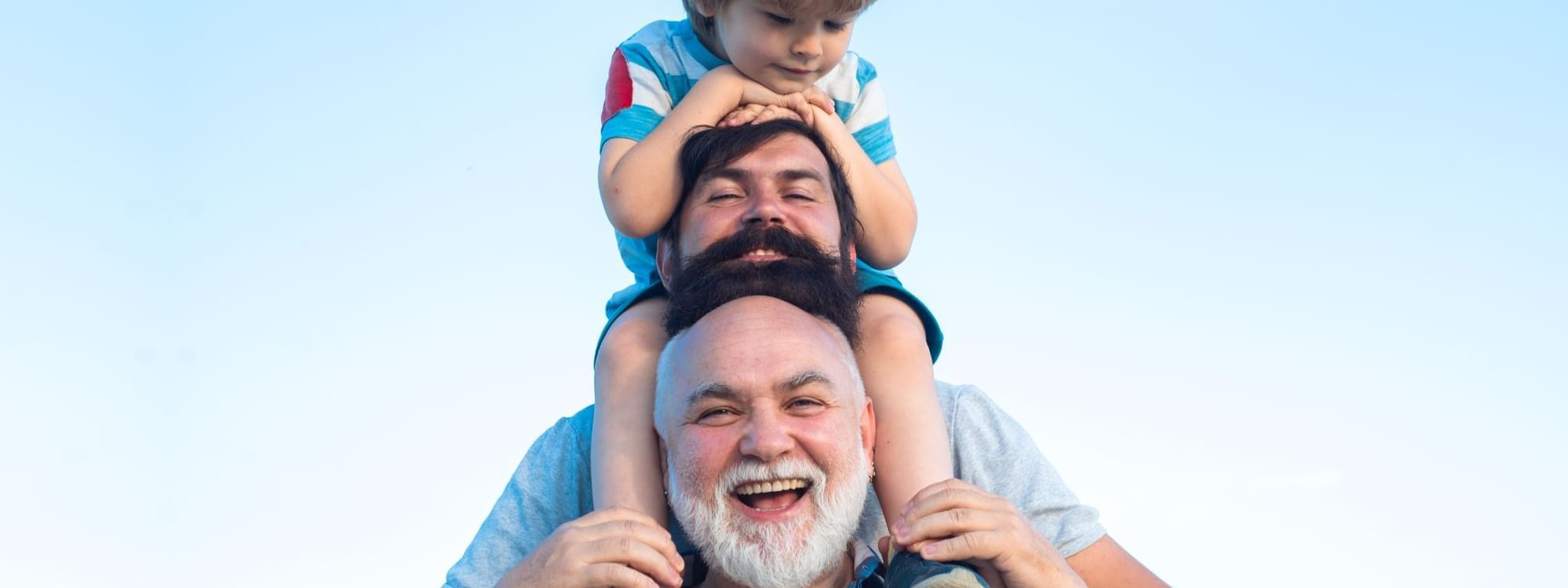 The image showcases three generations of fathers at Roc e Fiori