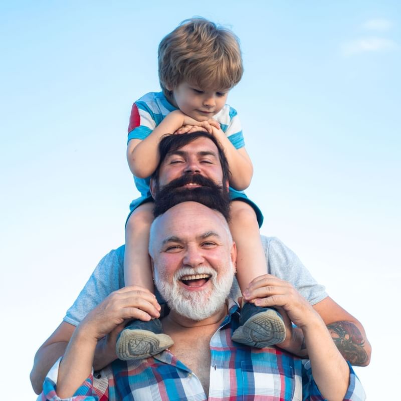 The image showcases three generations of fathers at Roc e Fiori