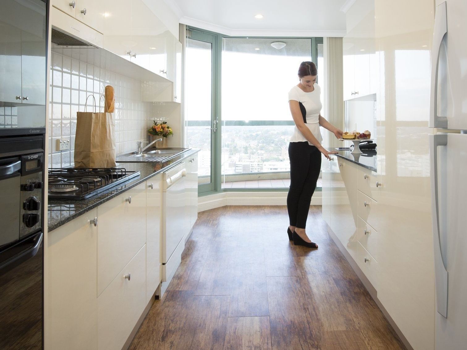 Lady cooking at the Sebel Residence Chatswood