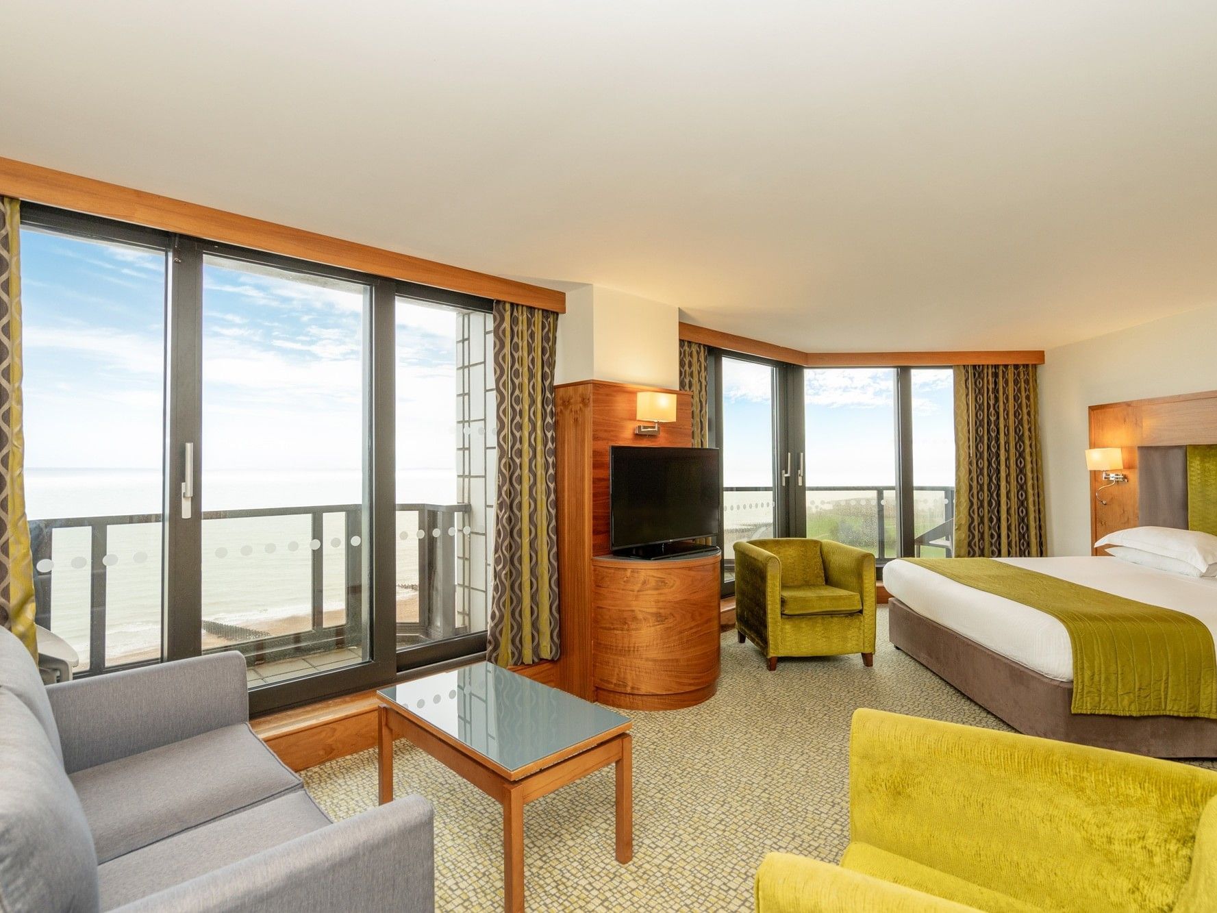 Spacious Executive Room with large window, furniture, and ocean view at The View Hotel Eastbourne, England.