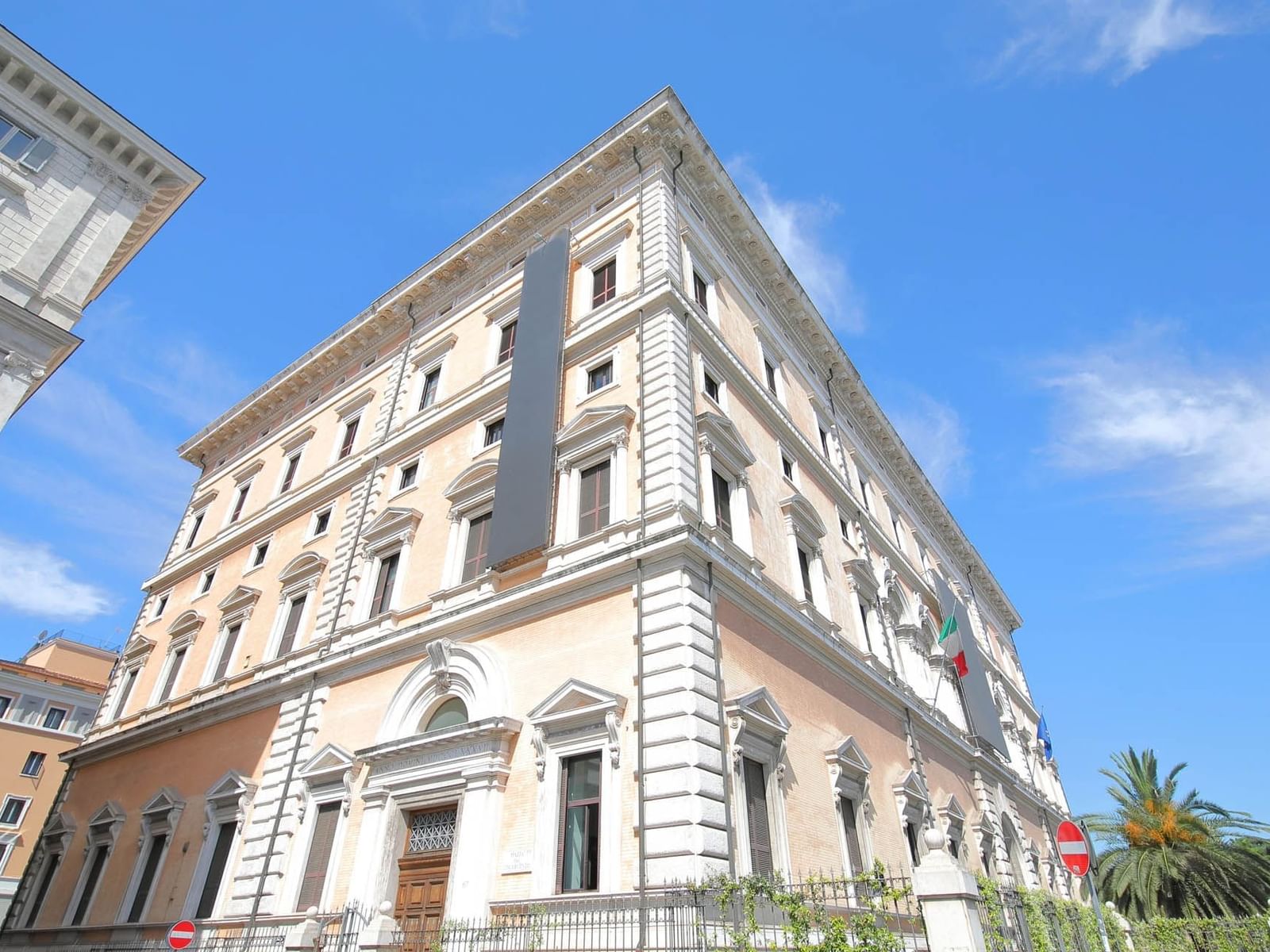National Roman Museum - Palazzo Massimo, with decorative elements, under a bright blue sky near The Guardian Hotel