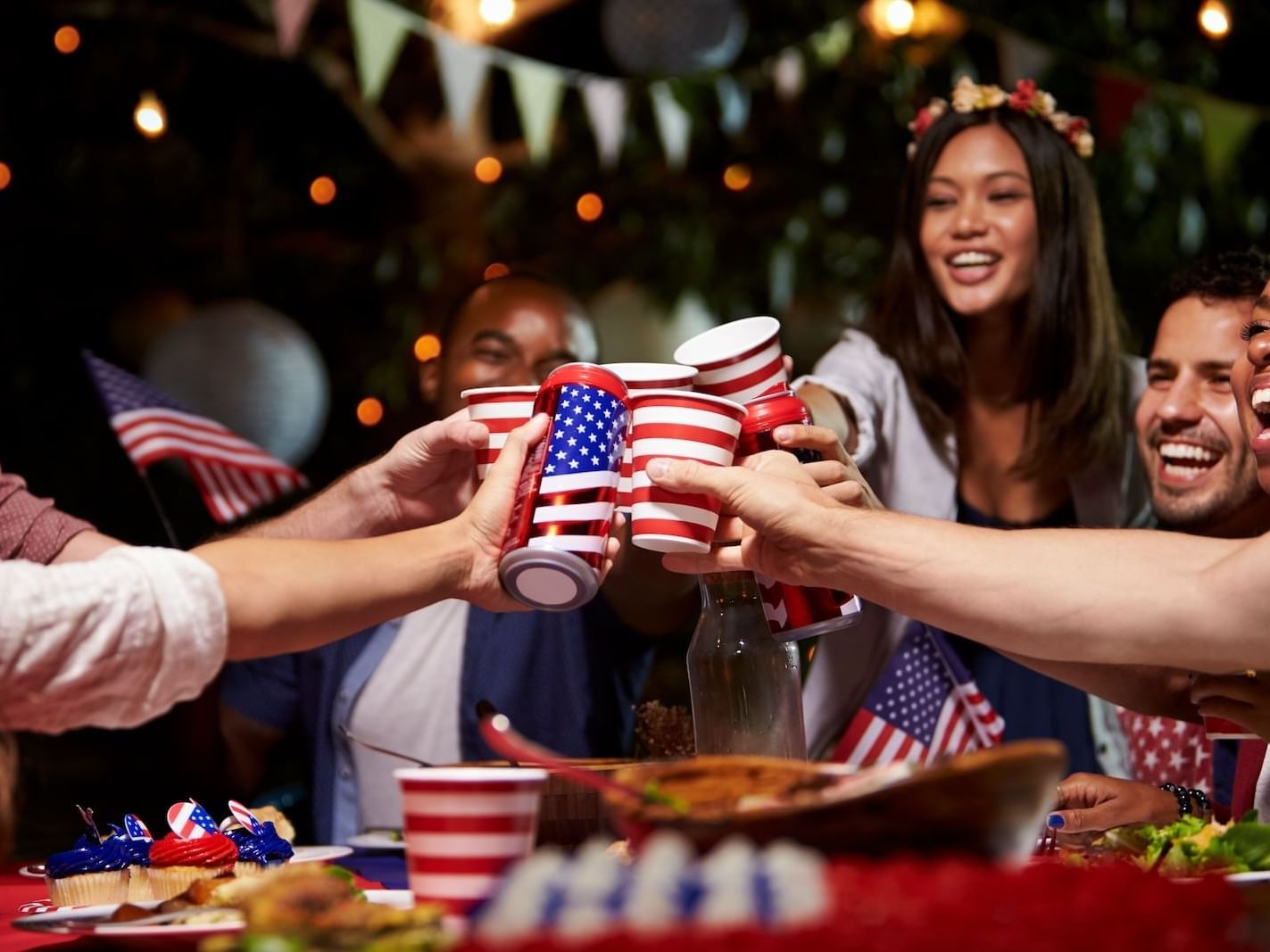 People holding American flags and toasting glasses at Stein Eriksen Lodge