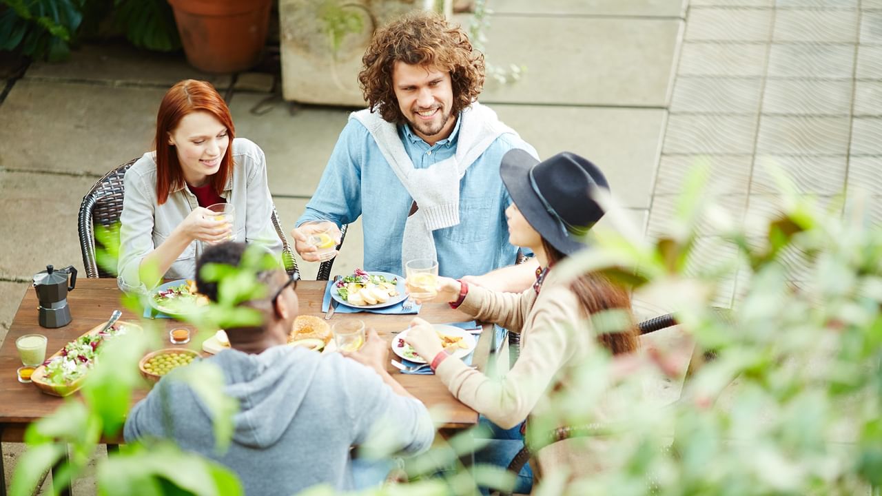 a group of friends enjoying breakfast in a garden