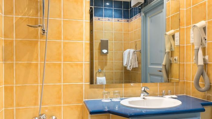 Bathroom vanity in bedrooms at Hotel des Orangers