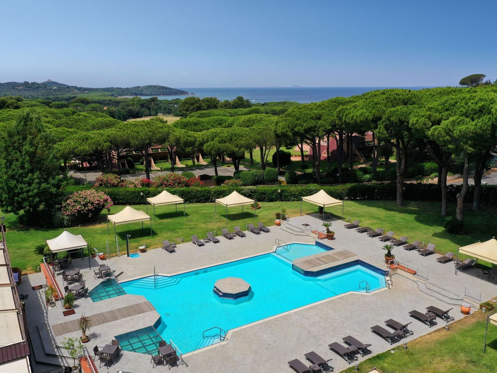 Aerial view of sunbeds by the outdoor pool area at Golf Hotel Punta Ala