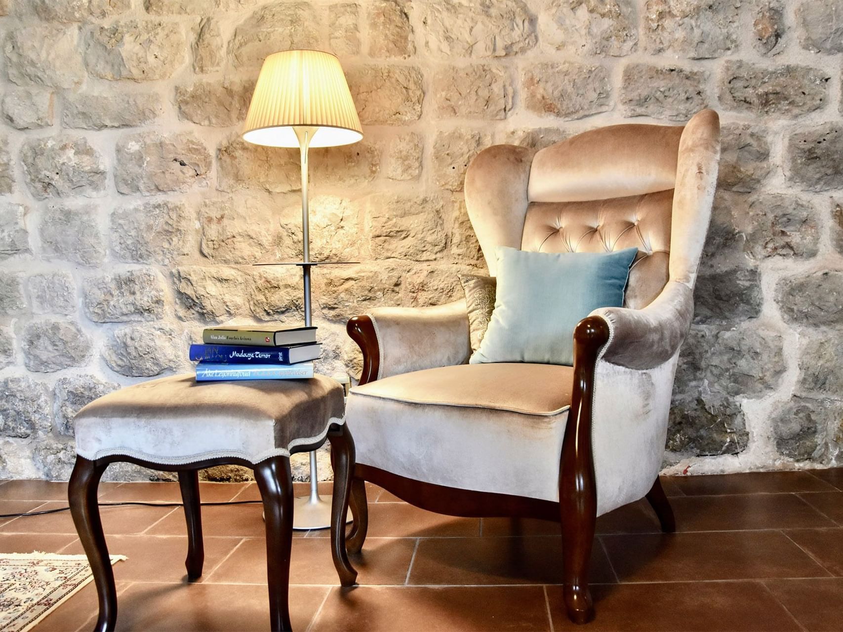 View of a chair and books on a table at Hotel Kazbek 