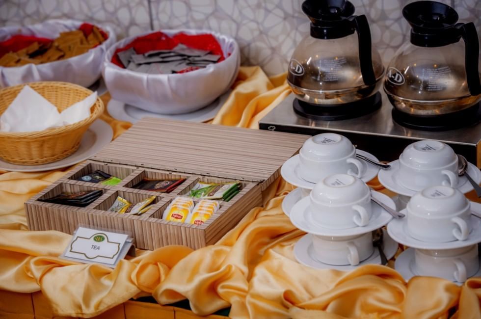 Buffet setup with teas, stacked cups, and coffee pots on a table at Sunway Hotel Georgetown