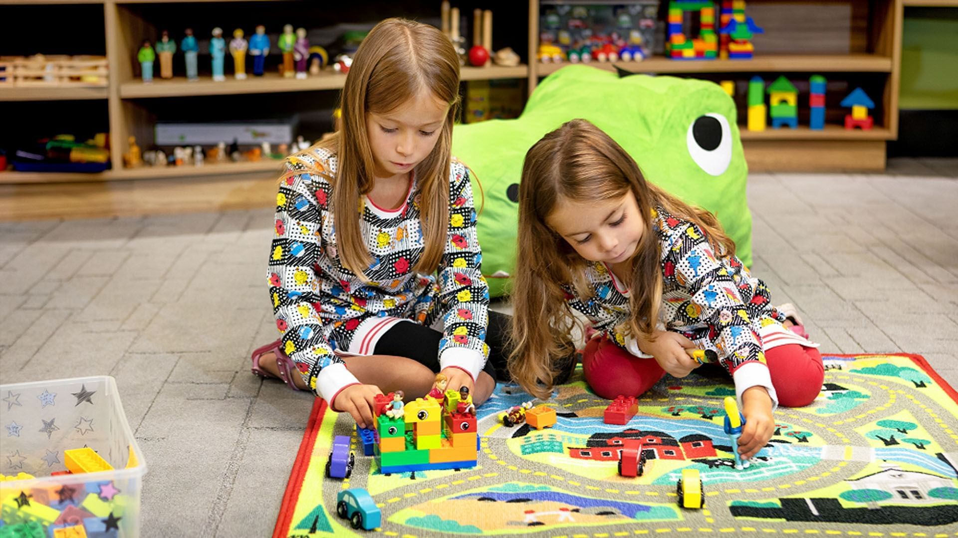 Two children playing with building blocks in the Play Centre at Hotel X, a downtown Toronto hotel