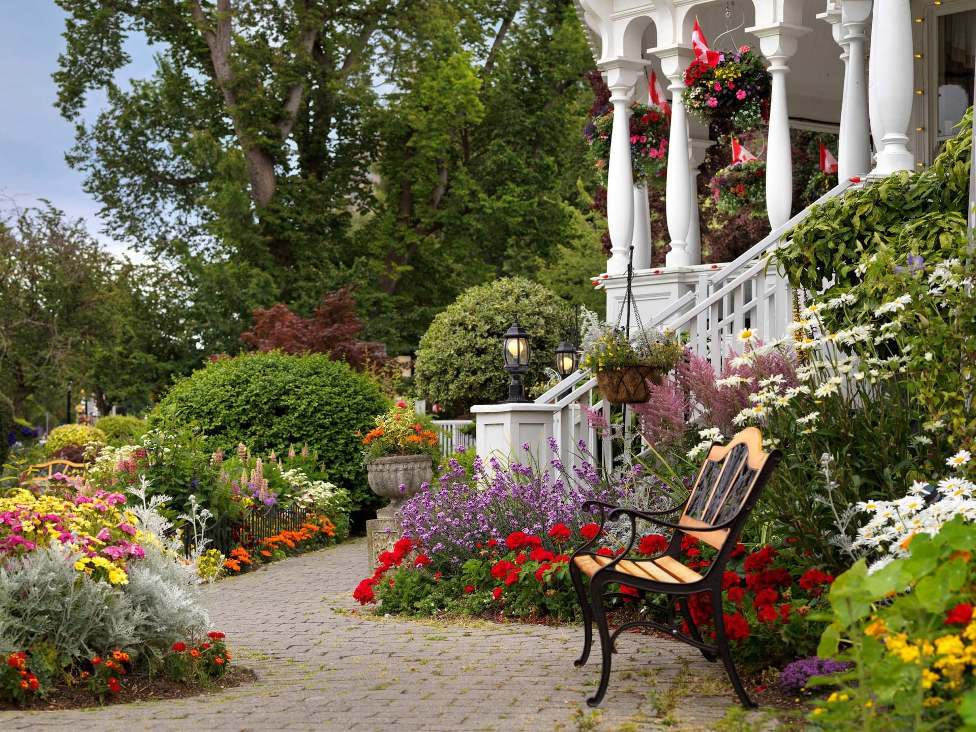 Charming bench surrounded by a well-maintained flower garden at Huntingdon Manor