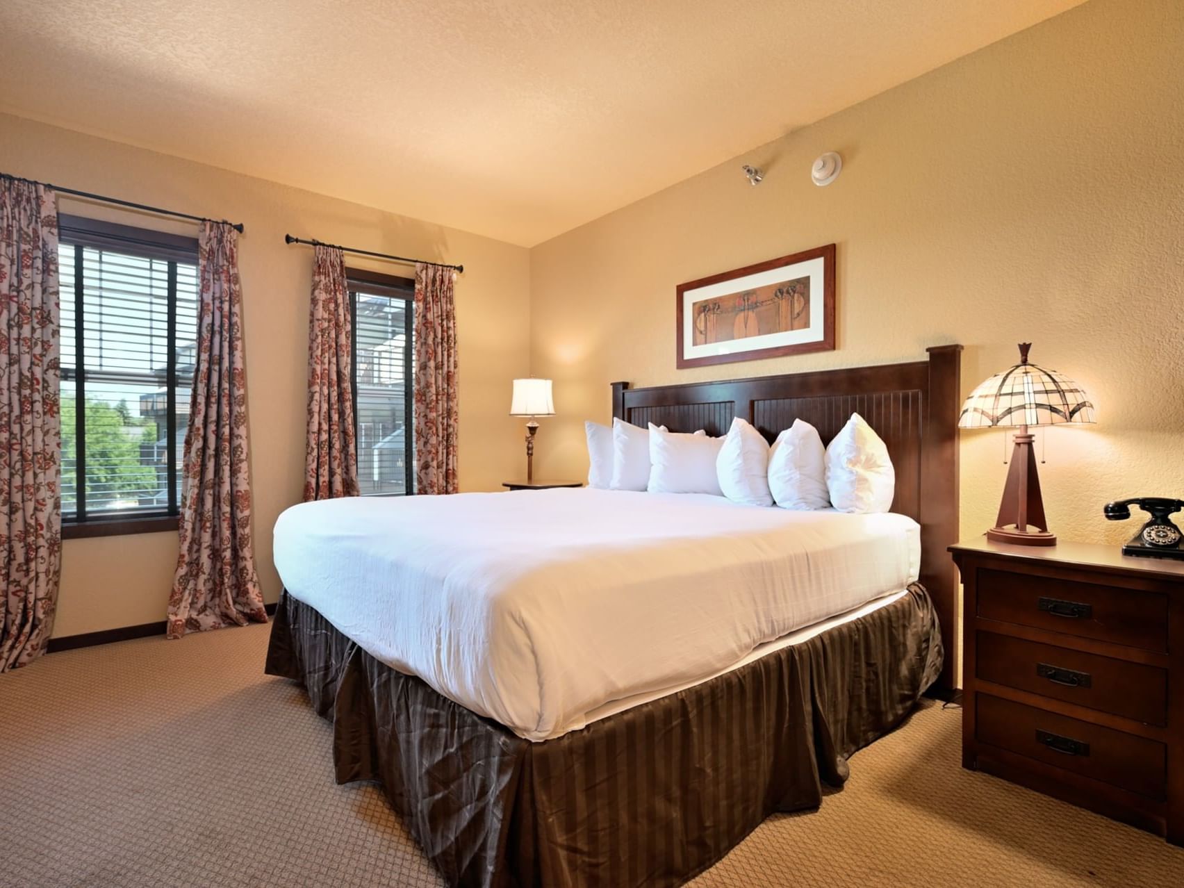 Bed & furniture in King Classic Hotel Room at Chase on The Lake
