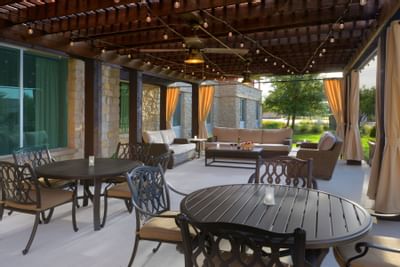 outdoor patio with assorted seating and hanging lights