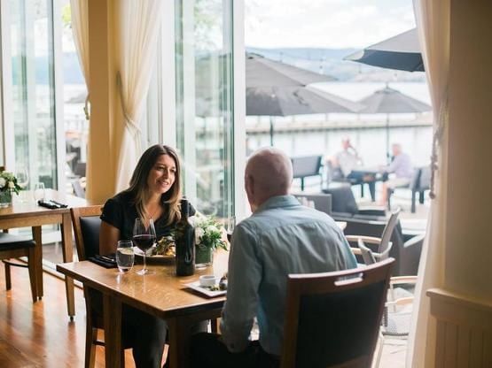 Couple dining at Lakeside Dining Room, Manteo Resort Waterfront