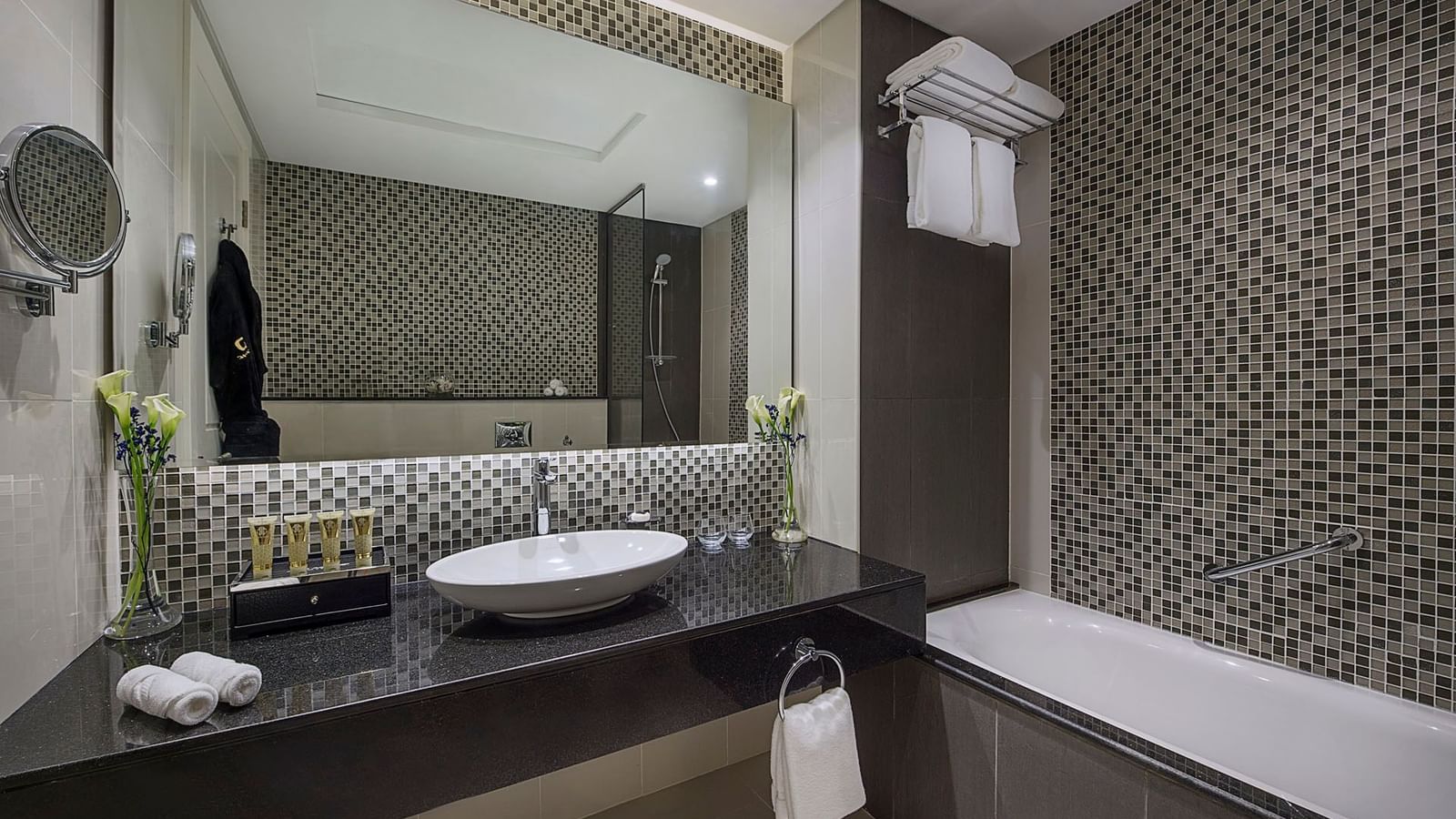 Bathtub, bathroom vanity with toiletries amenities in Two Bedroom Suite at DAMAC Maison Distinction