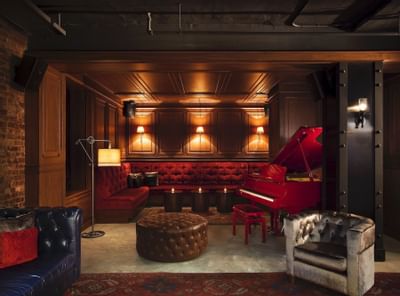 a large couch and piano in a lounge