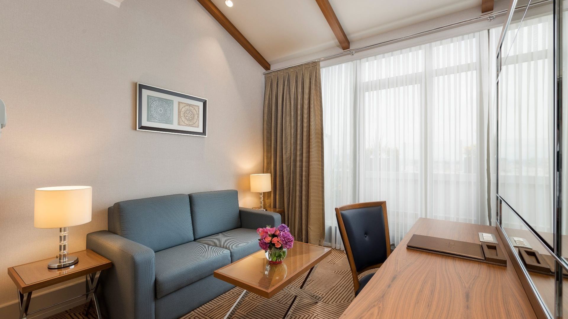 Lobby area with comfy sofa and working table in Executive Room at Titanic City Taksim