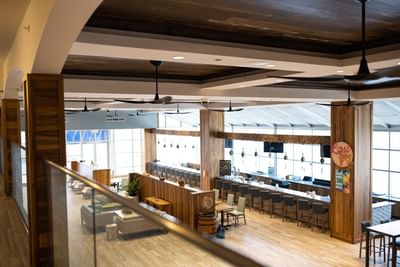High-angle view of the spacious Lost Key Bar featuring sleek wood and glass decor at Margaritaville Resort Biloxi