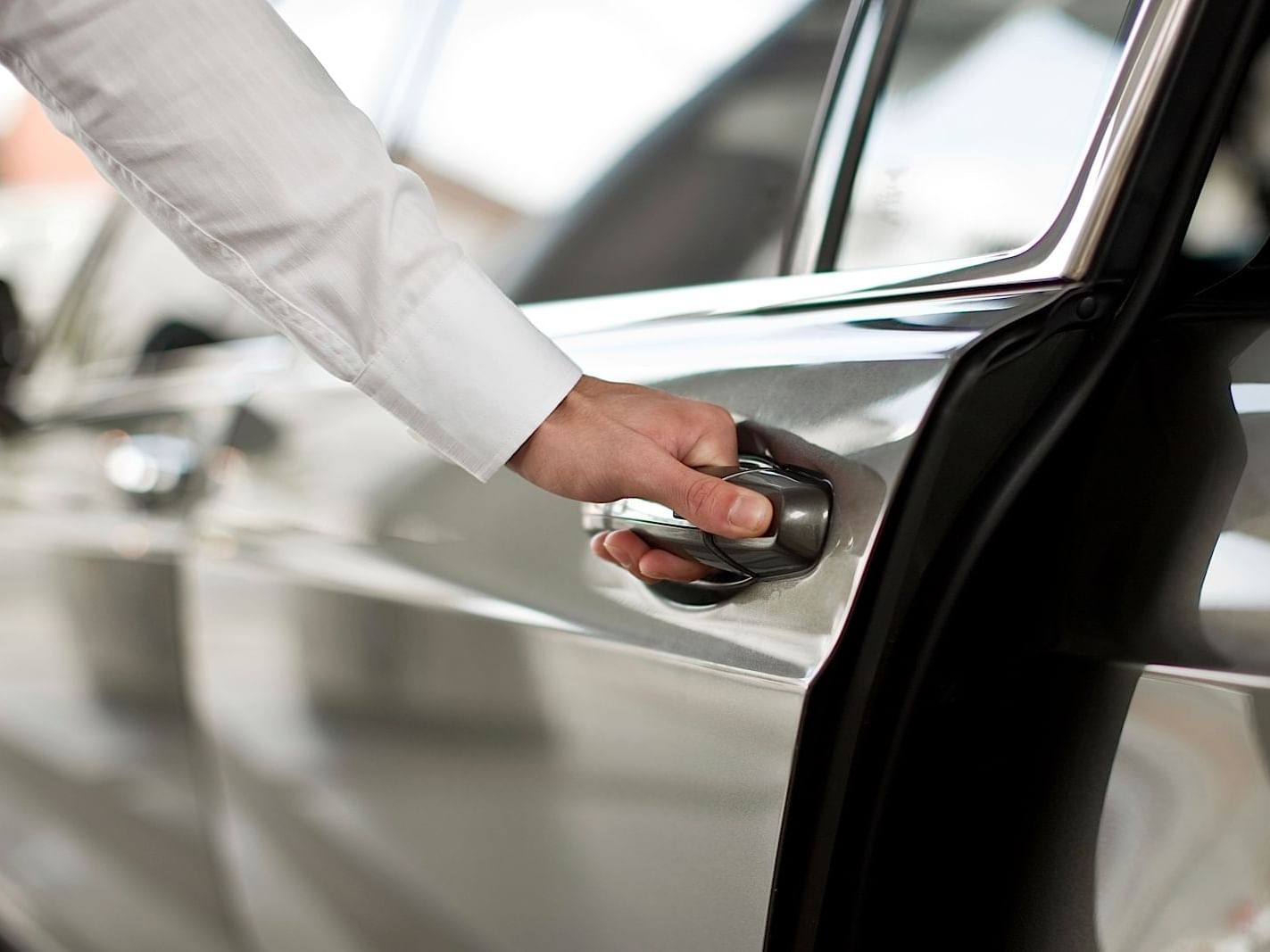 Close-up of hand holding car door handle at Dream Hollywood LA