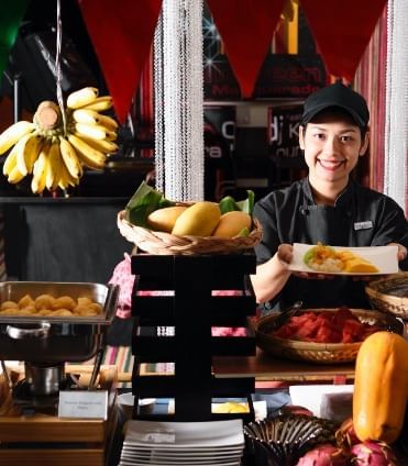 A girl serves food at a restaurant in Dream Thailand Bangkok