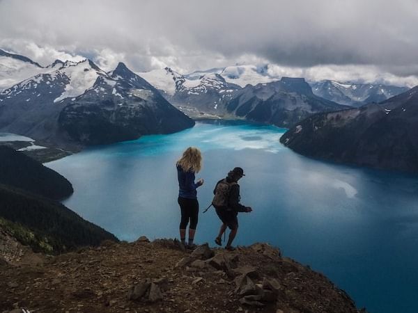 Photographers exploring the snowy mountains with a scenic view near Blackcomb Springs Suites