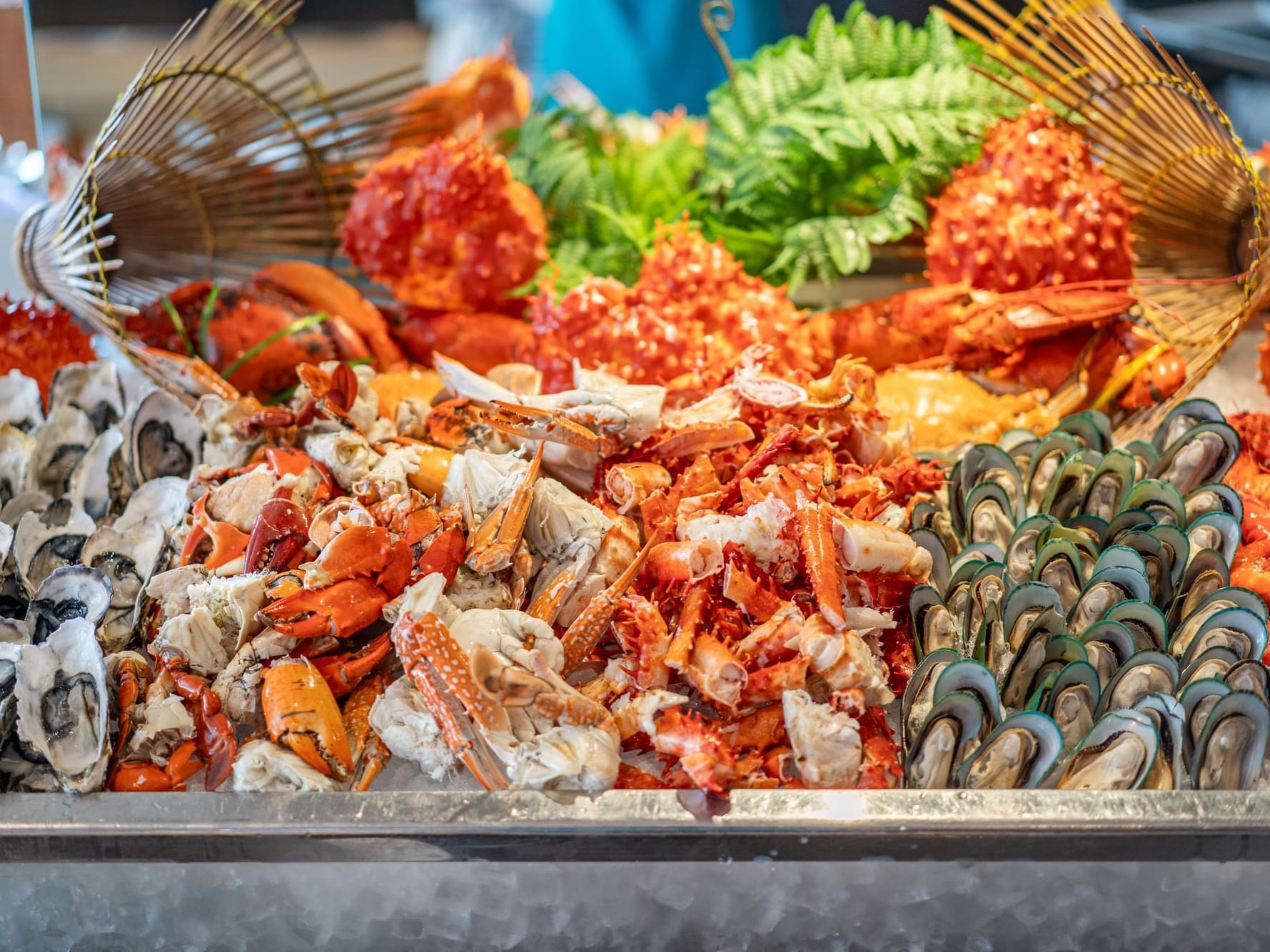 Seafood display featuring oysters, crab legs, and red whole crabs at Eastin Hotels