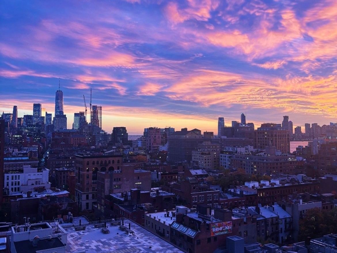 View from Gansevoort Hotel Rooftop, overlooking sunset views in downtown New York City. 