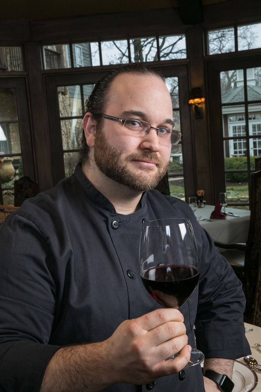 man holding a glass of red wine