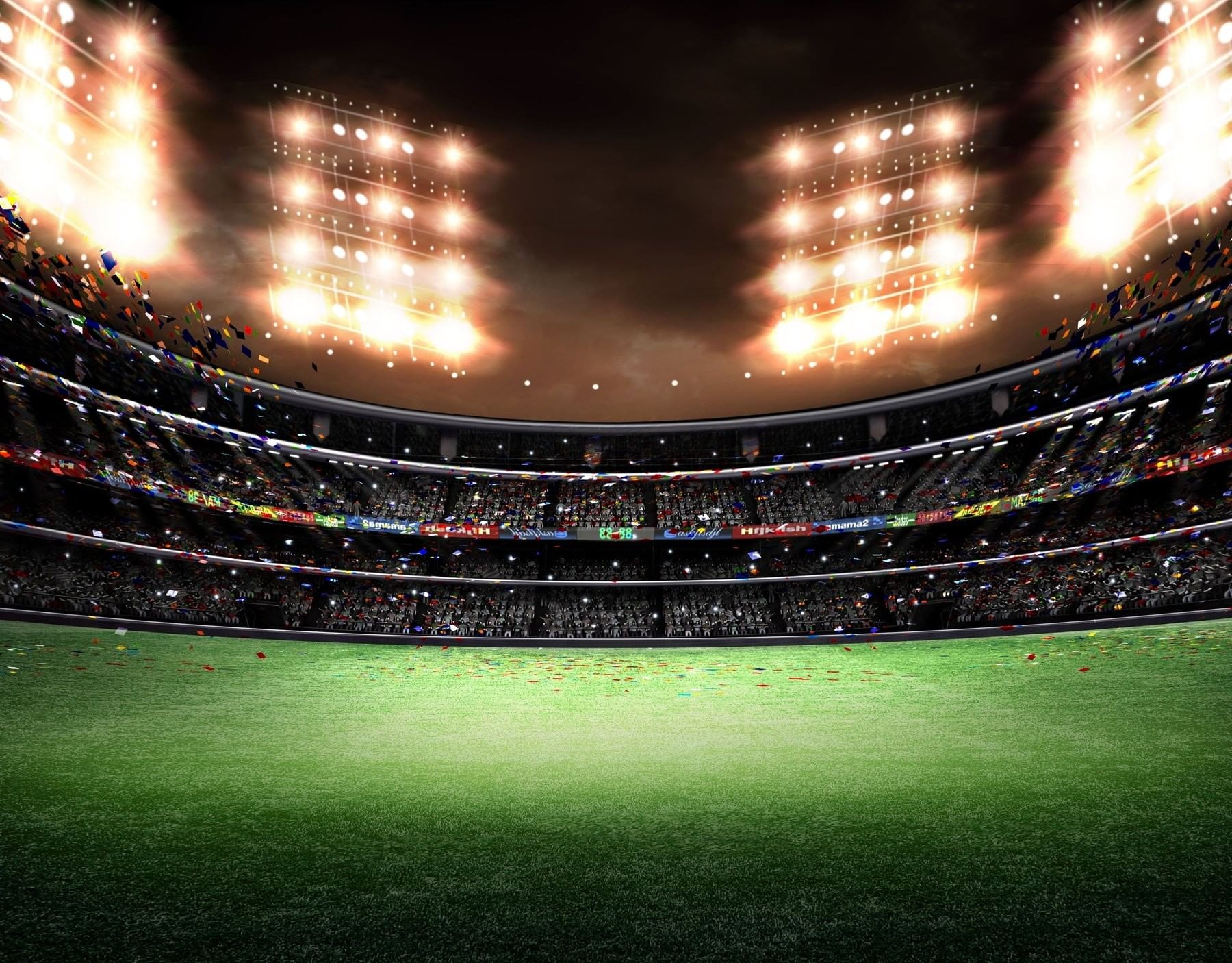 Empty sports stadium at night with bright lights over the field near The Inn at Celebration