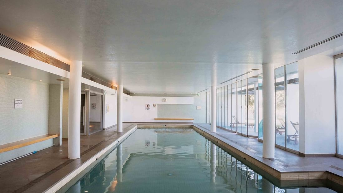 Heated Indoor Pool surrounded by glass walls at Pullman Magenta Shores