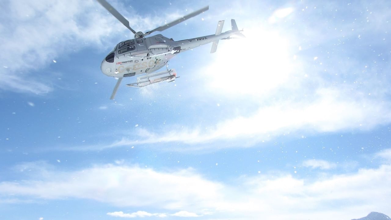 Helicopter flying over snowy mountain