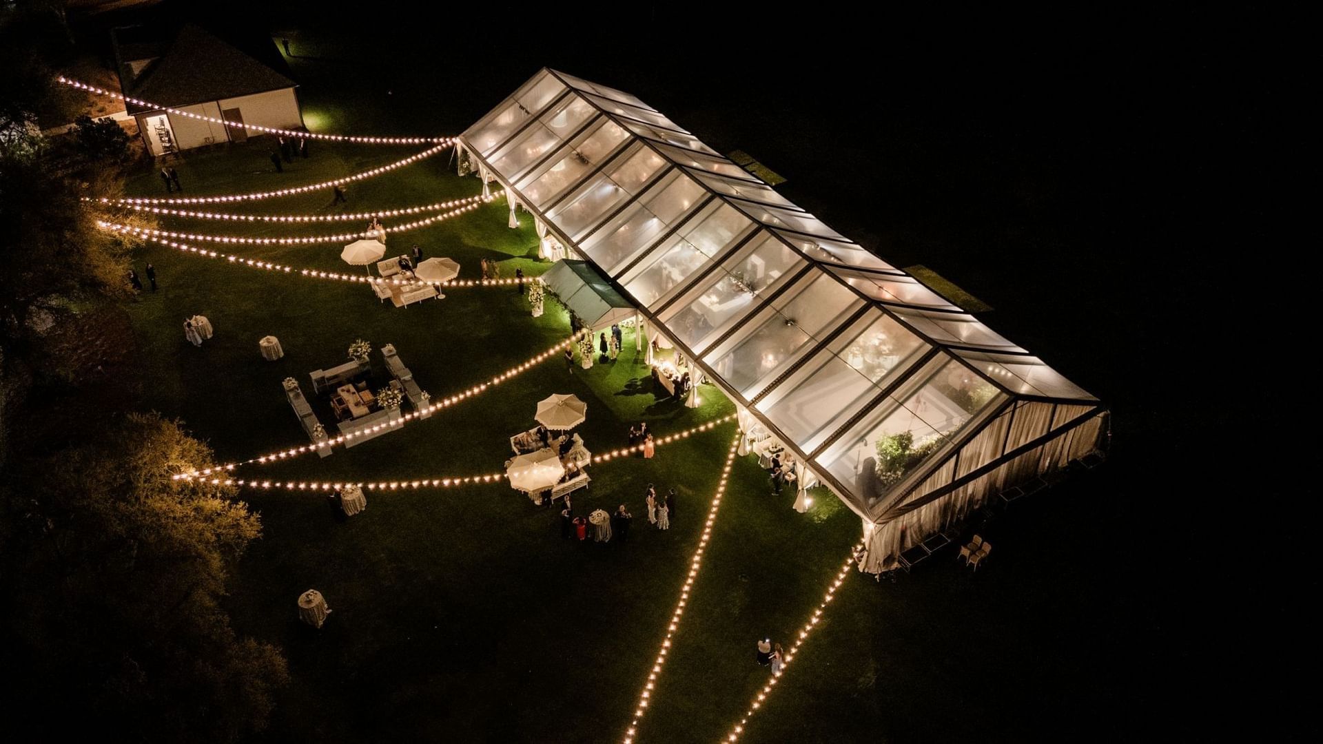 An aerial view of the Camp Creek Driving Range wedding tent at night at Camp Creek Inn in Inlet Beach.