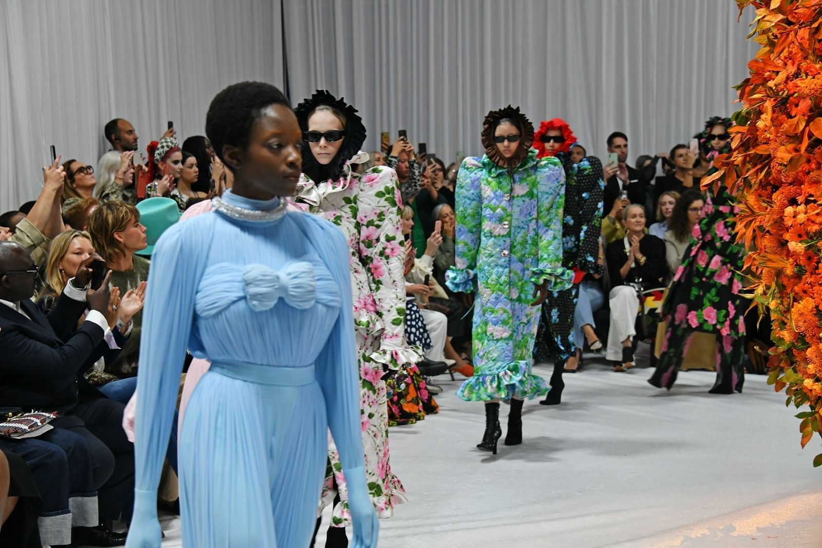 Models in vibrant, artistic gowns walking the runway during London Fashion Week 2022 at The Londoner