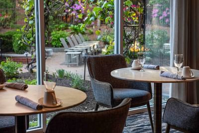 Dining table arrangement in Harbor Bistro with carpeted floors at Portland Harbor Hotel