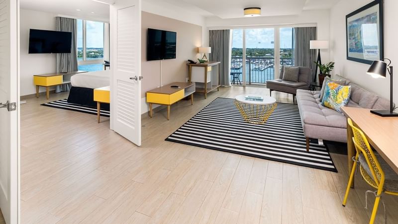 Spacious living room by the balcony in One Bedroom Harbourfront Suite at Warwick Paradise Island Bahamas