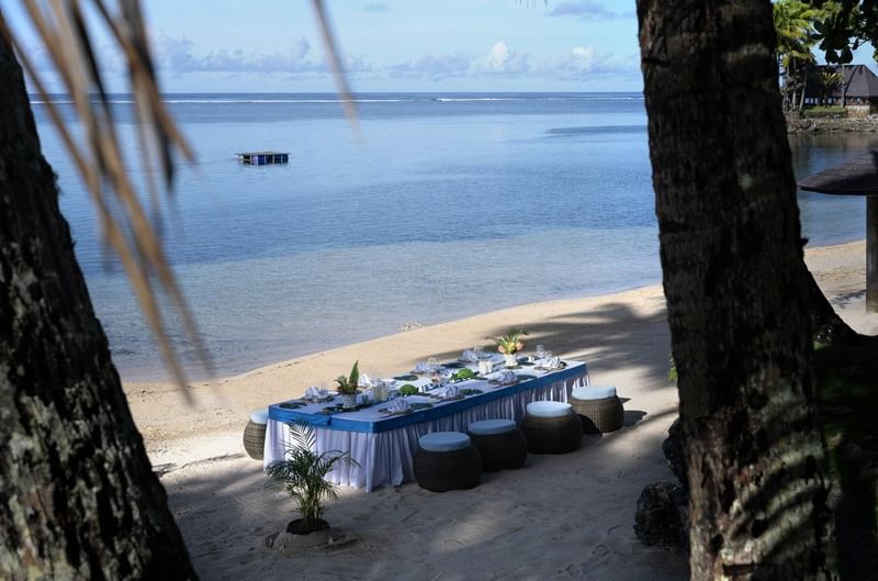 Beachside dining table setup for guests at Warwick Fiji Resort and Spa