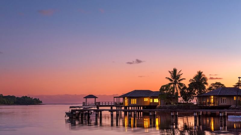 Overview of Overwater Villas at Warwick Le Lagon at sunset