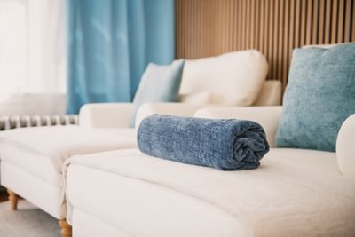 Rolled spa towel on a lounge chair at The Spa at Anchorage By The Sea