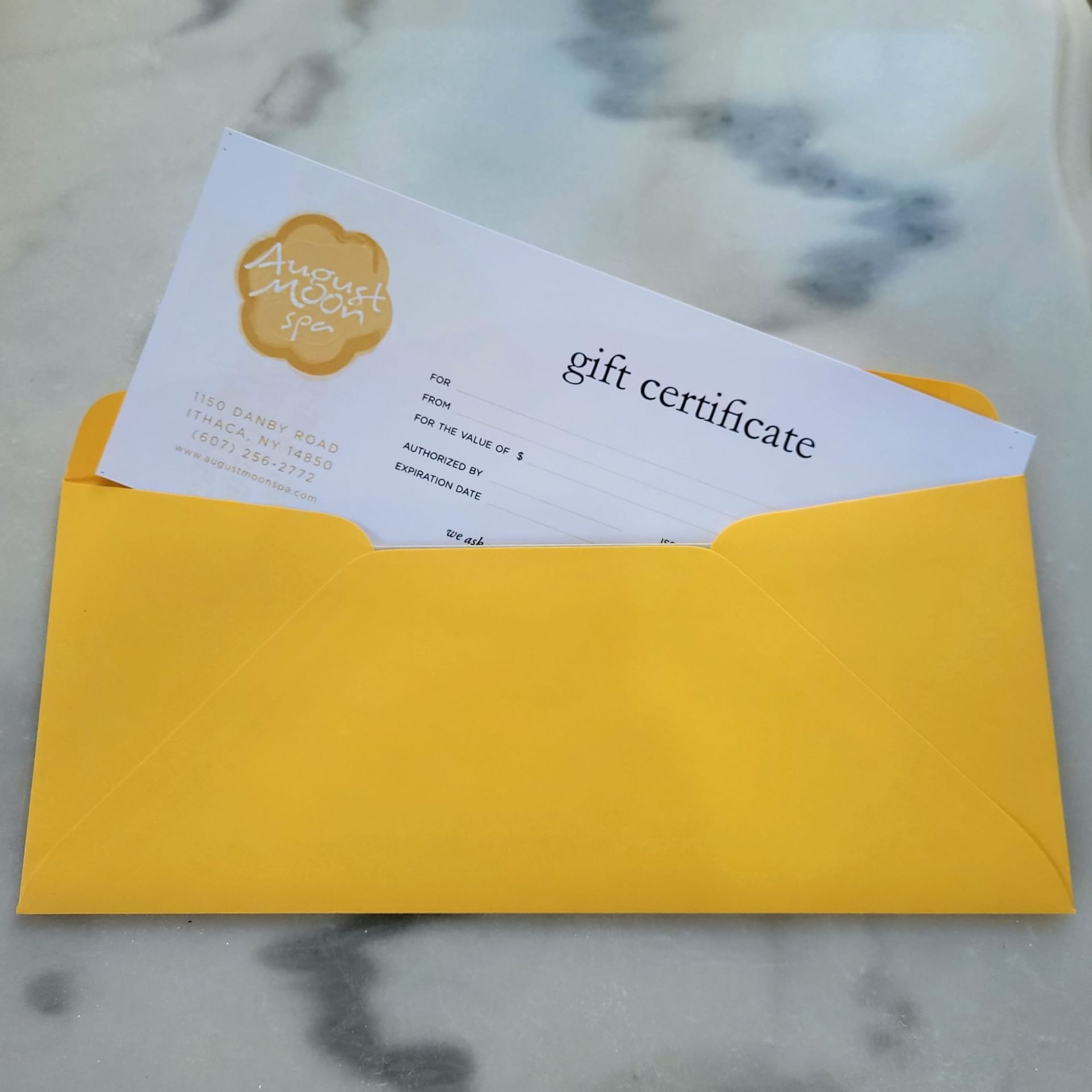 Closeup of gift certificate & envelop at August Moon Spa