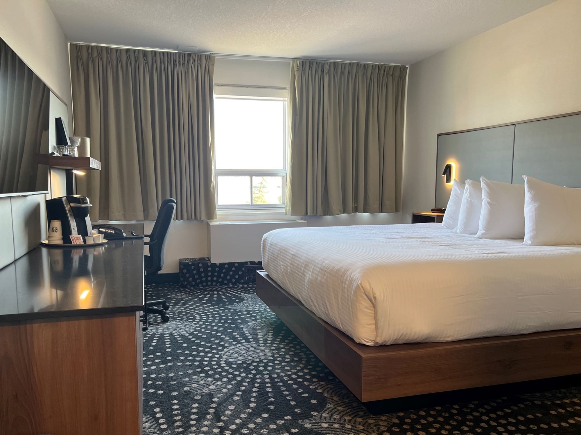 Bed & side cupboard in Standard 1 King at Carriage House Hotel