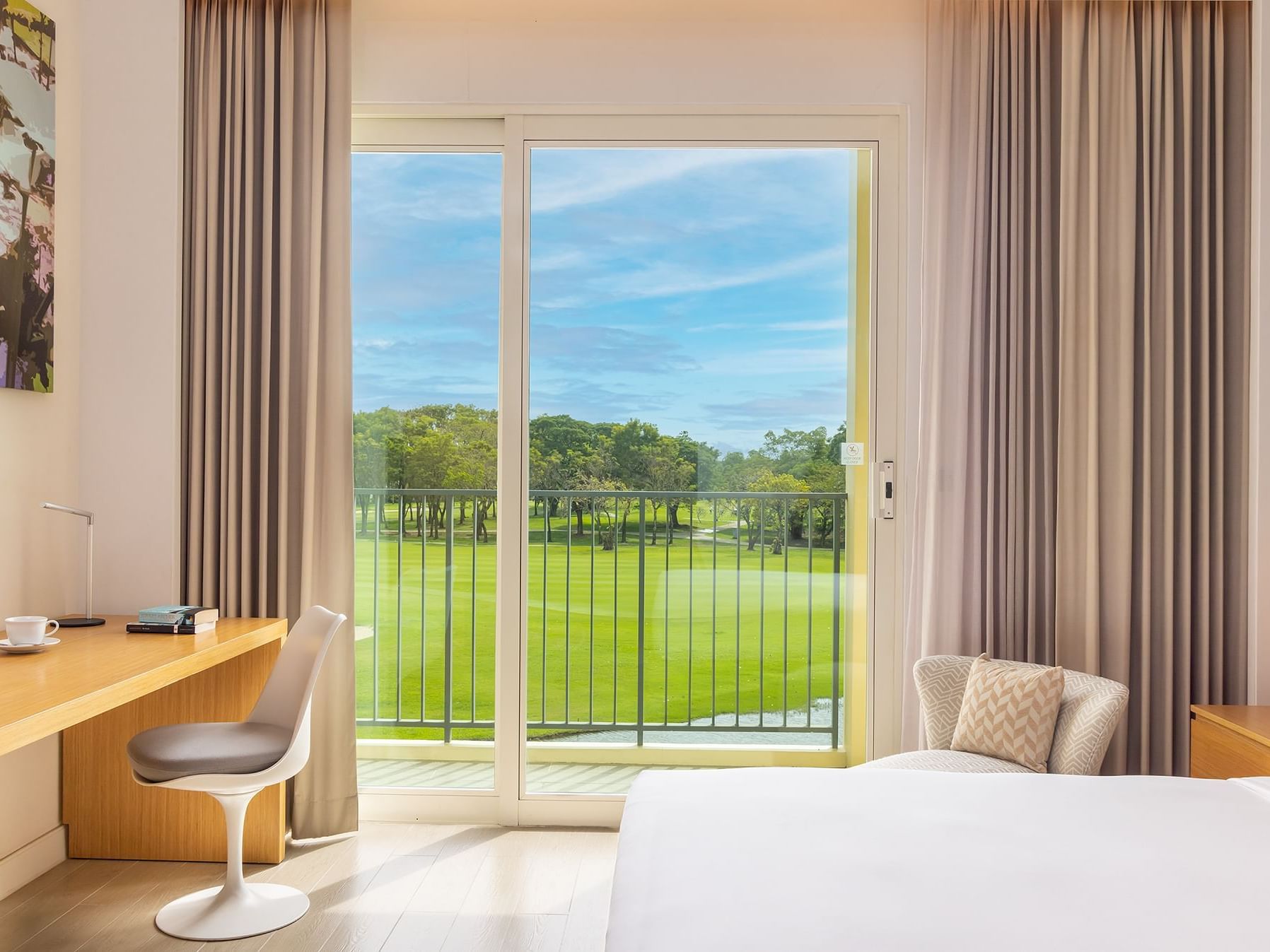 Bed & work area in Superior Room with Golf Course View at Eastin Thana City Golf Resort Bangkok