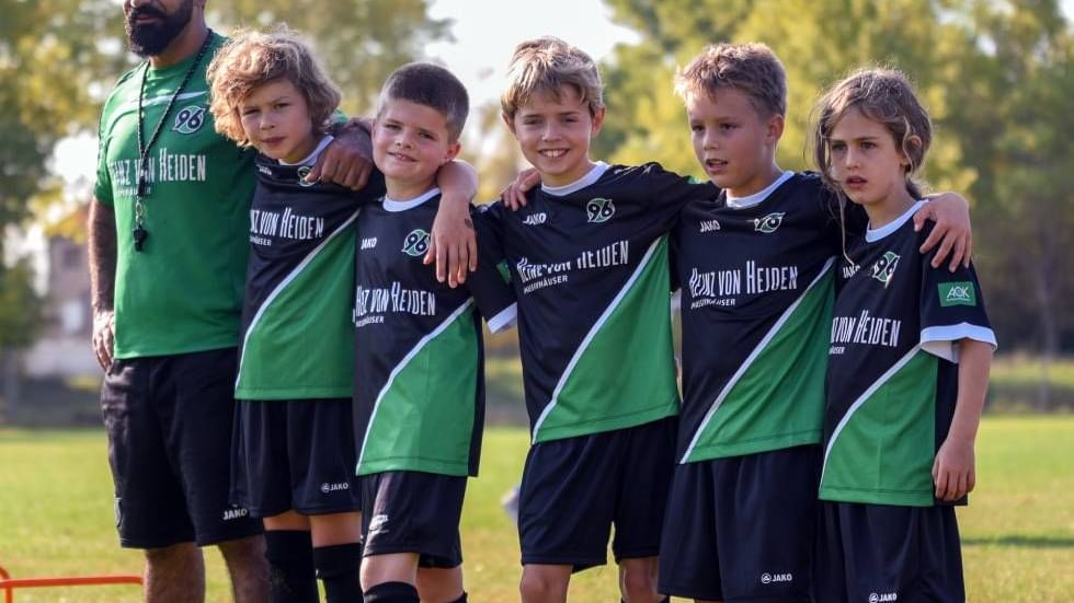 Kids of a soccer team with the coach near Falkensteiner Hotels