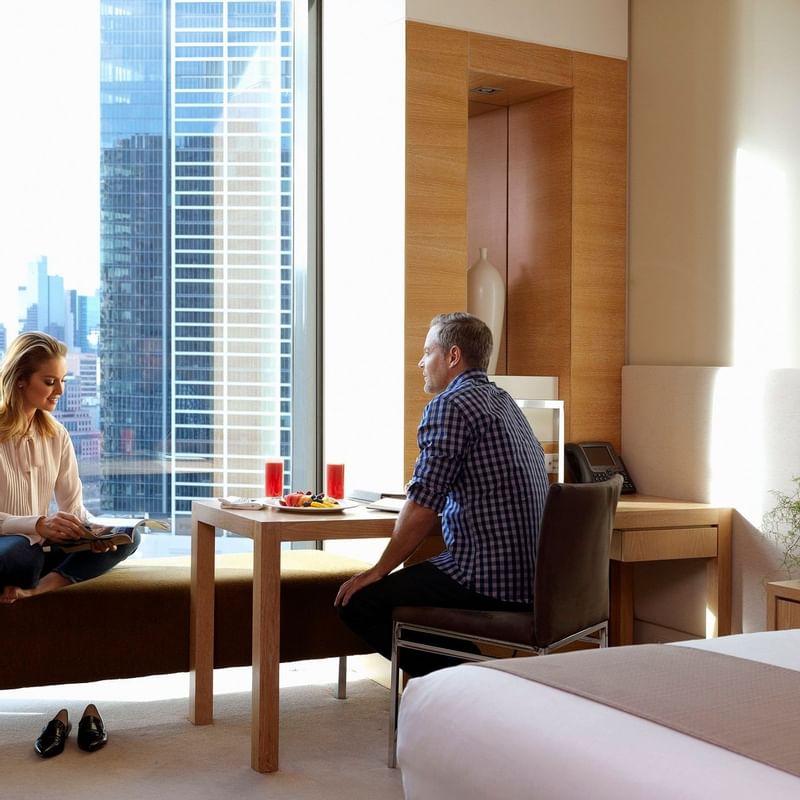 Couple in a bedroom at Crown Promenade Melbourne