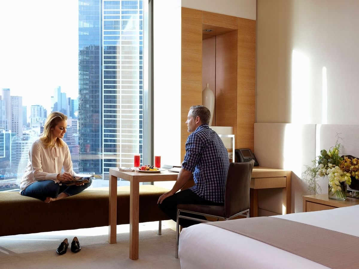 Couple in a bedroom at Crown Promenade Melbourne