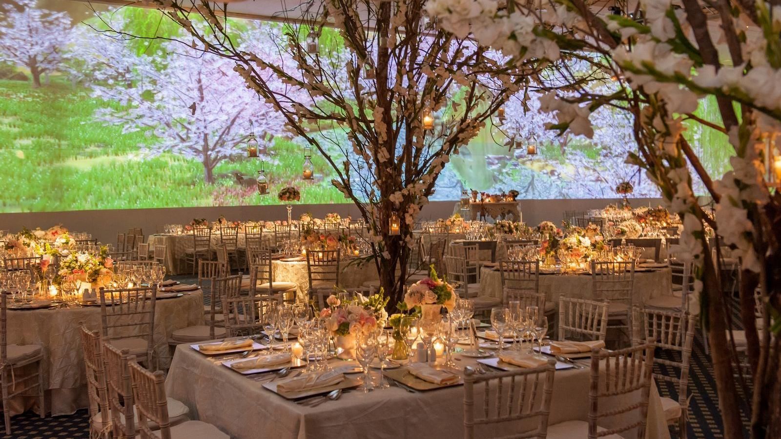 Decorated dining tables in the ballroom at Live Aqua Resorts