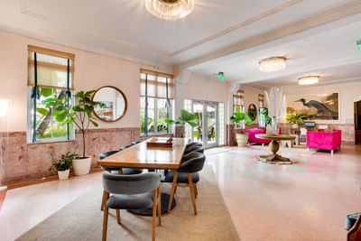 Lobby with a community table & sofas at South Beach Hotel