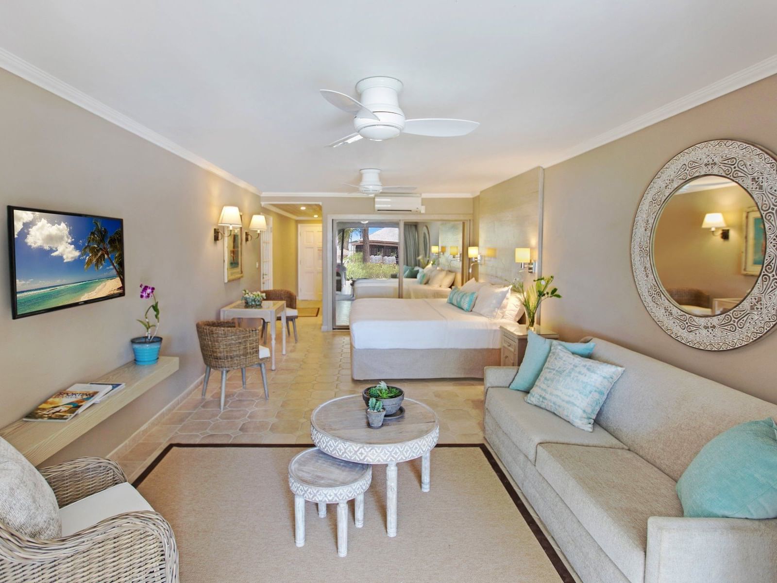 A Bed, couch & TV in Junior Suite at Bougainvillea Barbados